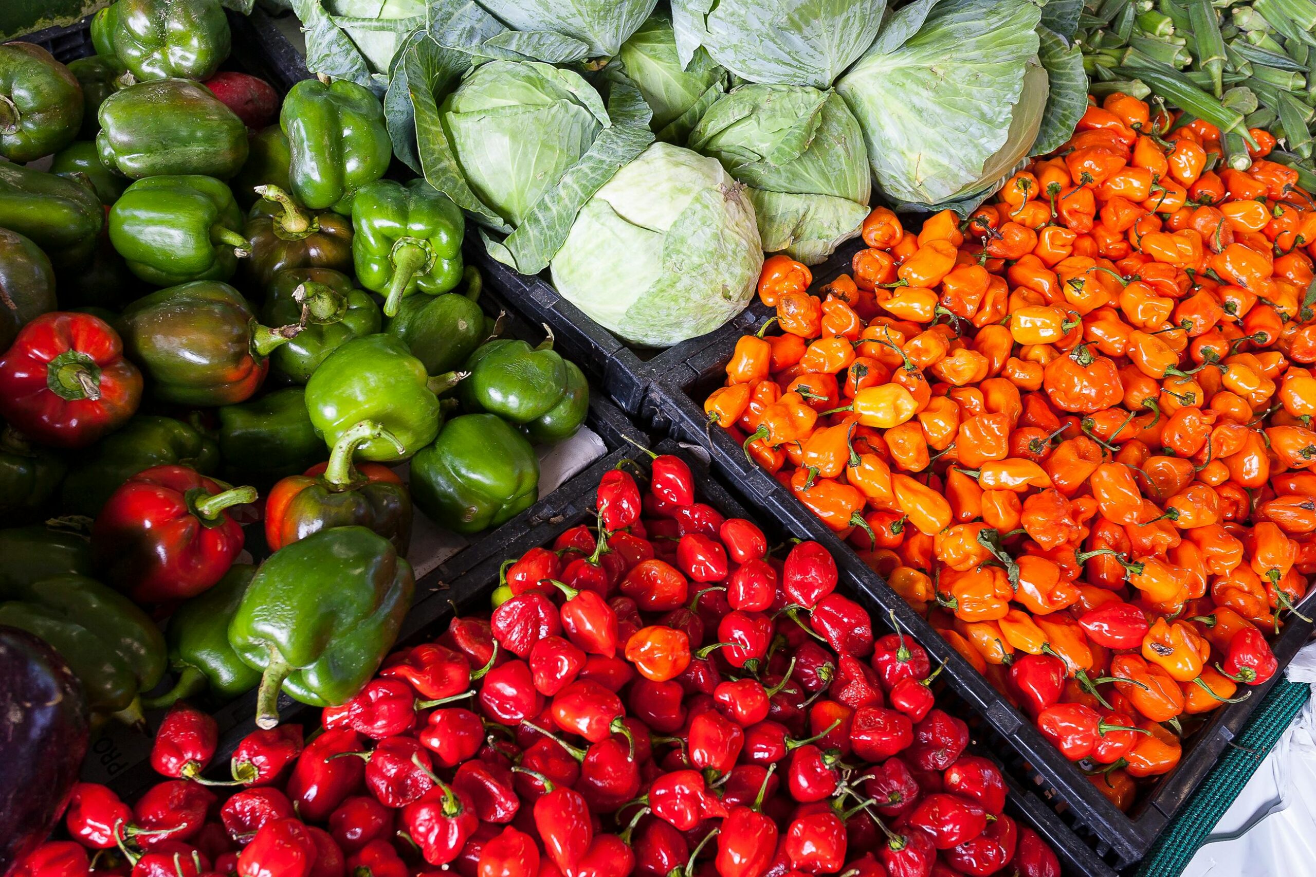 pexels photo 2252584 2252584 A vibrant display of fresh vegetables including peppers and cabbage at an outdoor market.